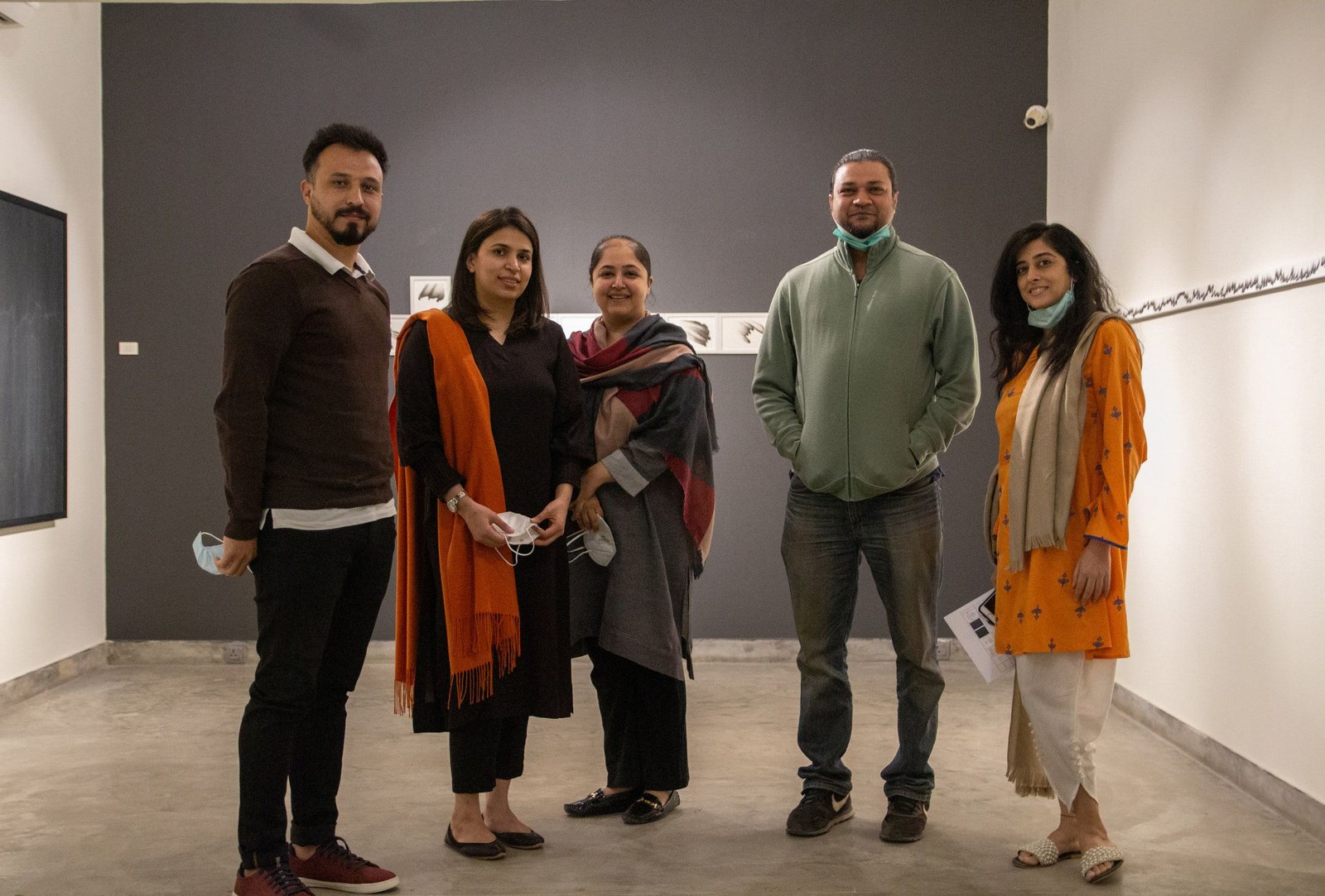 The artists and guests standing together in the gallery at the opening