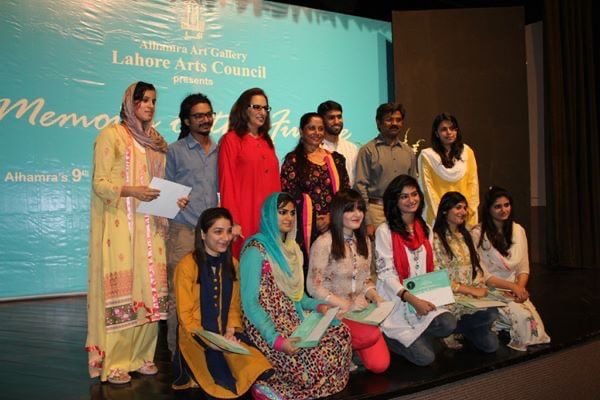 Group of young artists holding certificates on stage at Alhamra Art Gallery